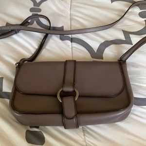 Leather Michael Kors crossbody gray in color